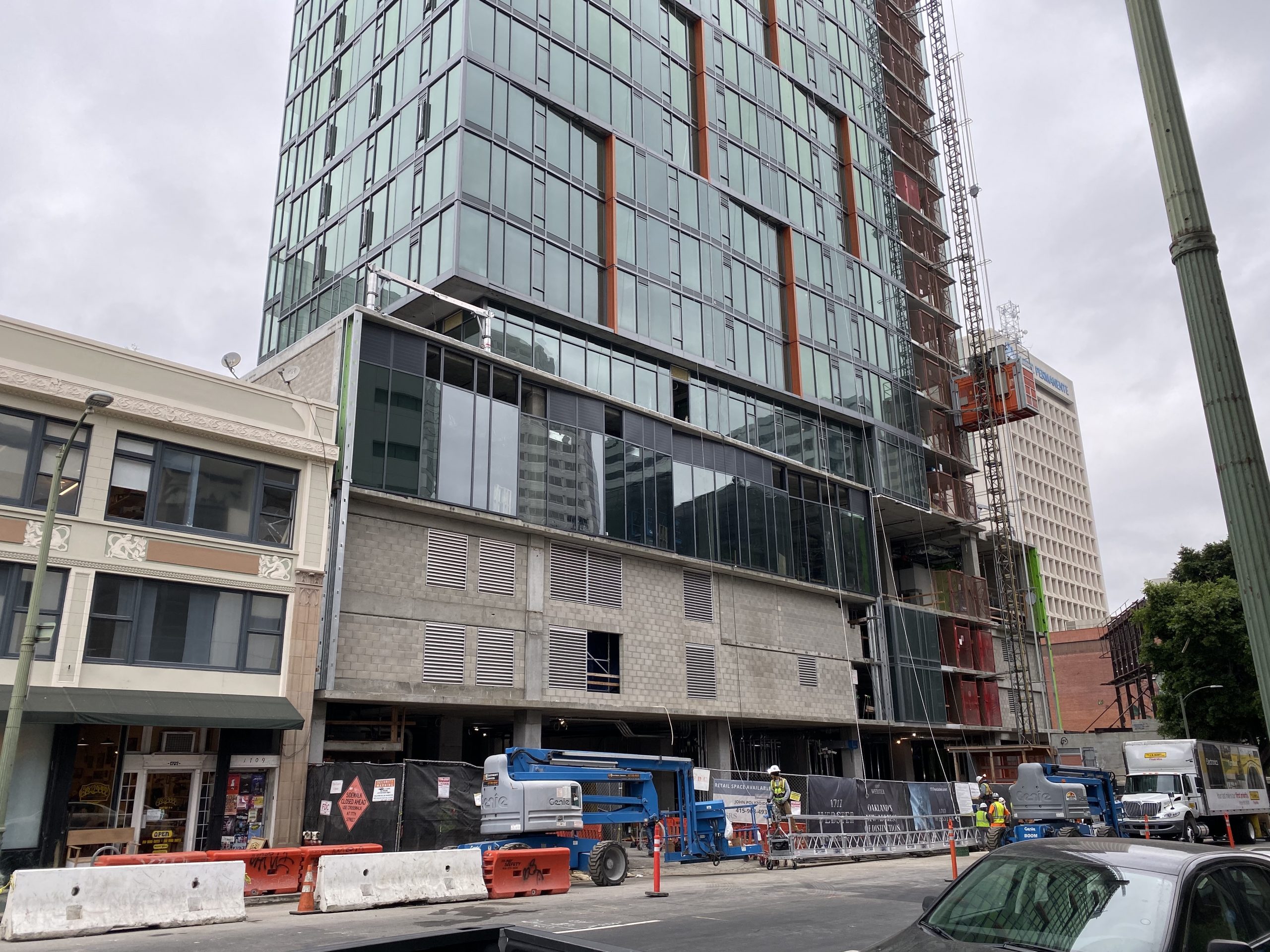 A construction zone for a parking garage below a high rise building